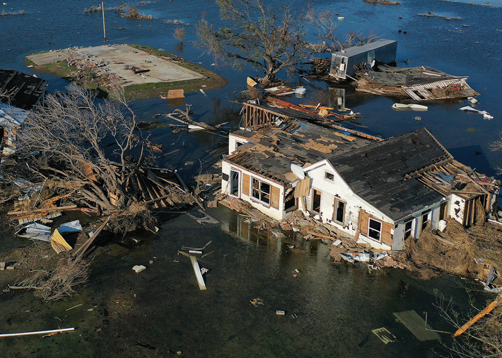 Flood waters from Hurricane Delta surrounding structures destroyed by Hurricane Laura in Creole, Louisiana.