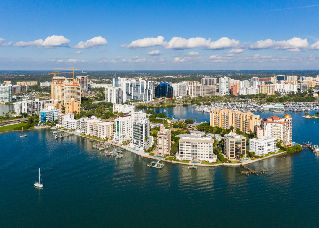 The sun shines on buildings near the water