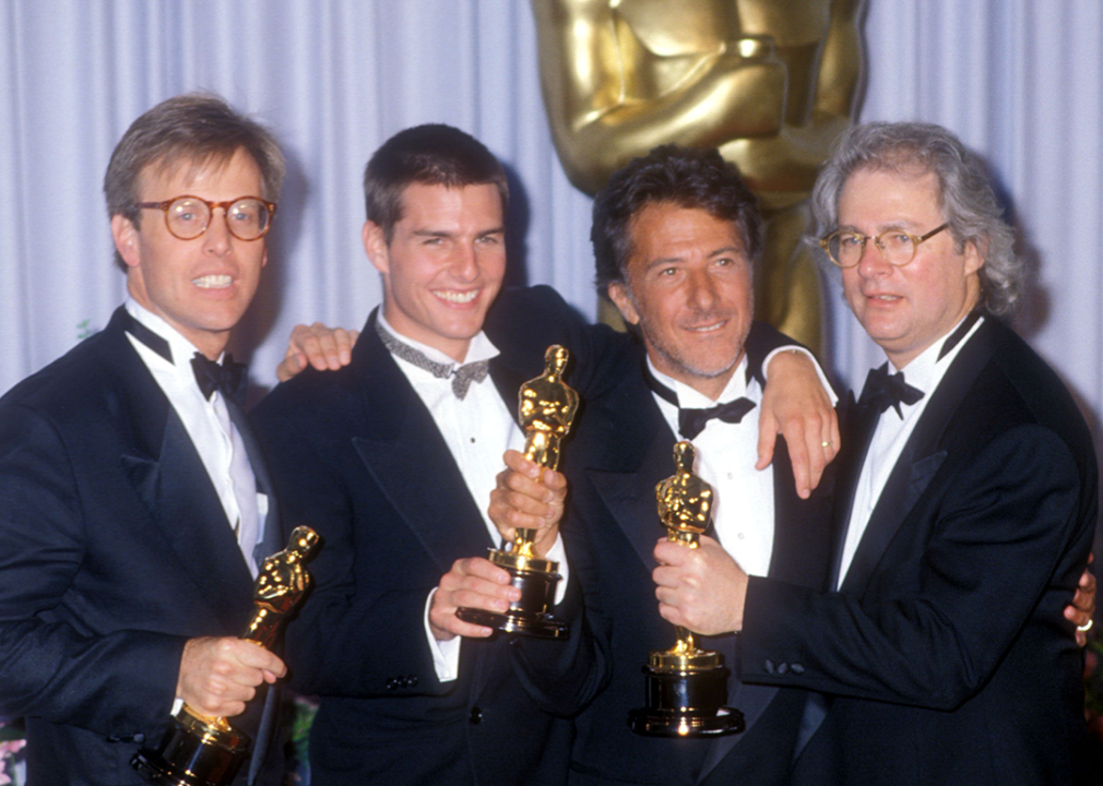 Mark Johnson, Tom Cruise, Dustin Hoffman, and Barry Levinson pose with Academy Awards.