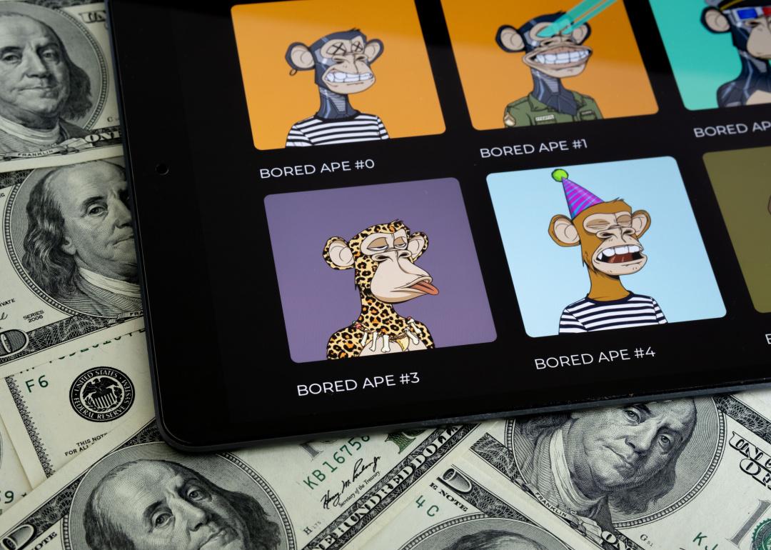 A digital display showing Bored Ape NFTs on $100 dollar bills.