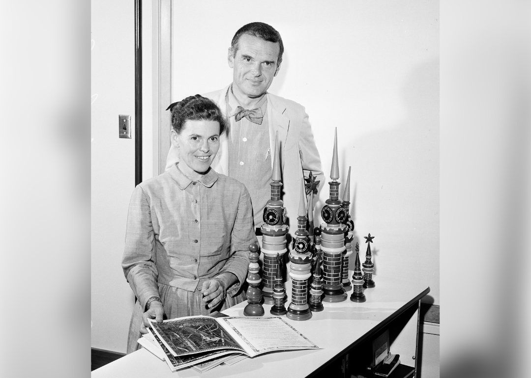 Charles and Ray Eames pose with Russian toys and books.