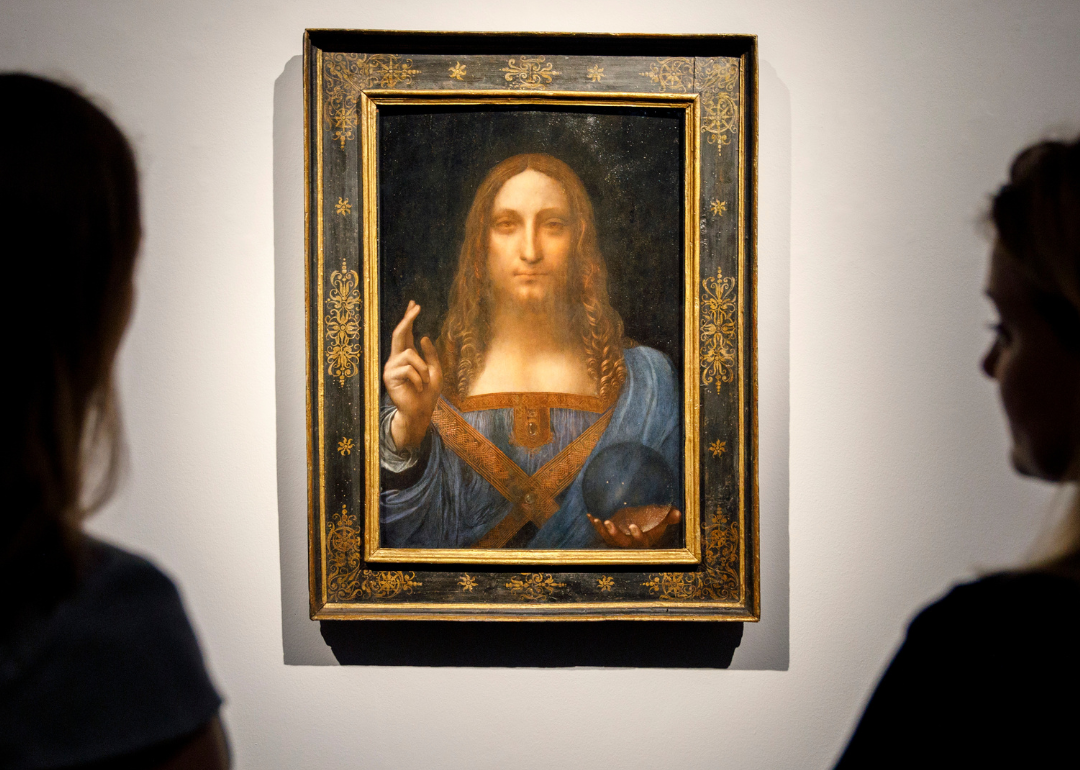 Christie's employees pose in front of Salvator Mundi.