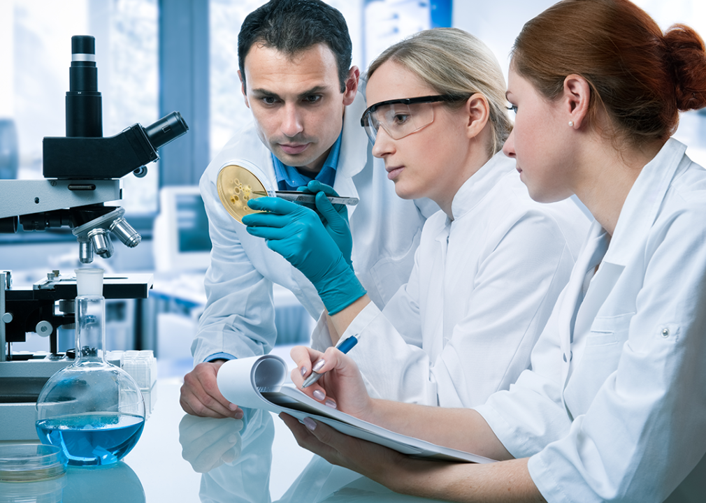 Three scientists working in a laboratory.