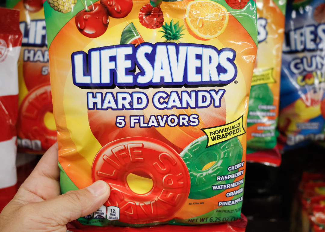 Hand holding Life Savers Hard Candy package.