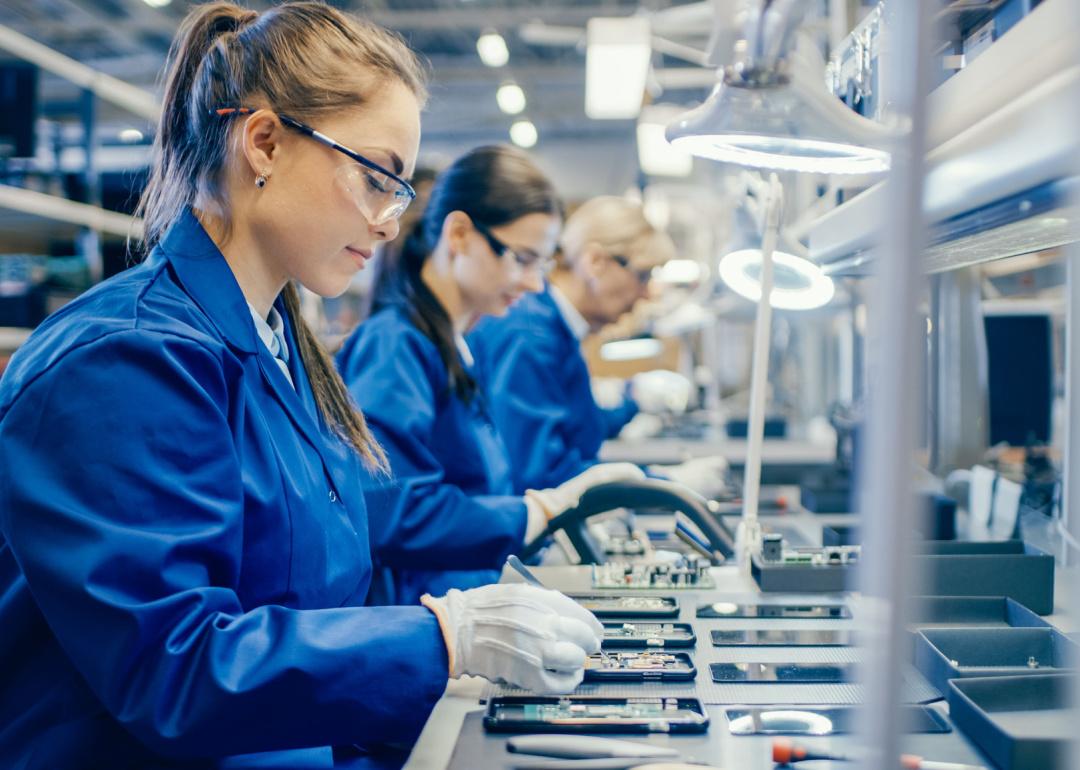 Women assembling circuit boards for smartphones.