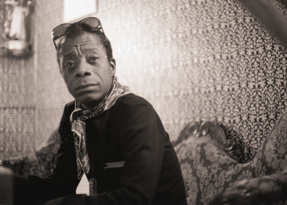 Portrait of James Baldwin seated.