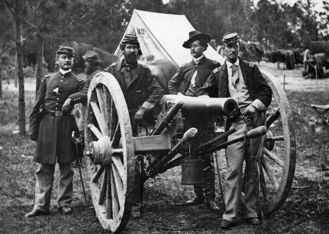 Four Civil War artillery officers grouped around a cannon near Fair Oaks.