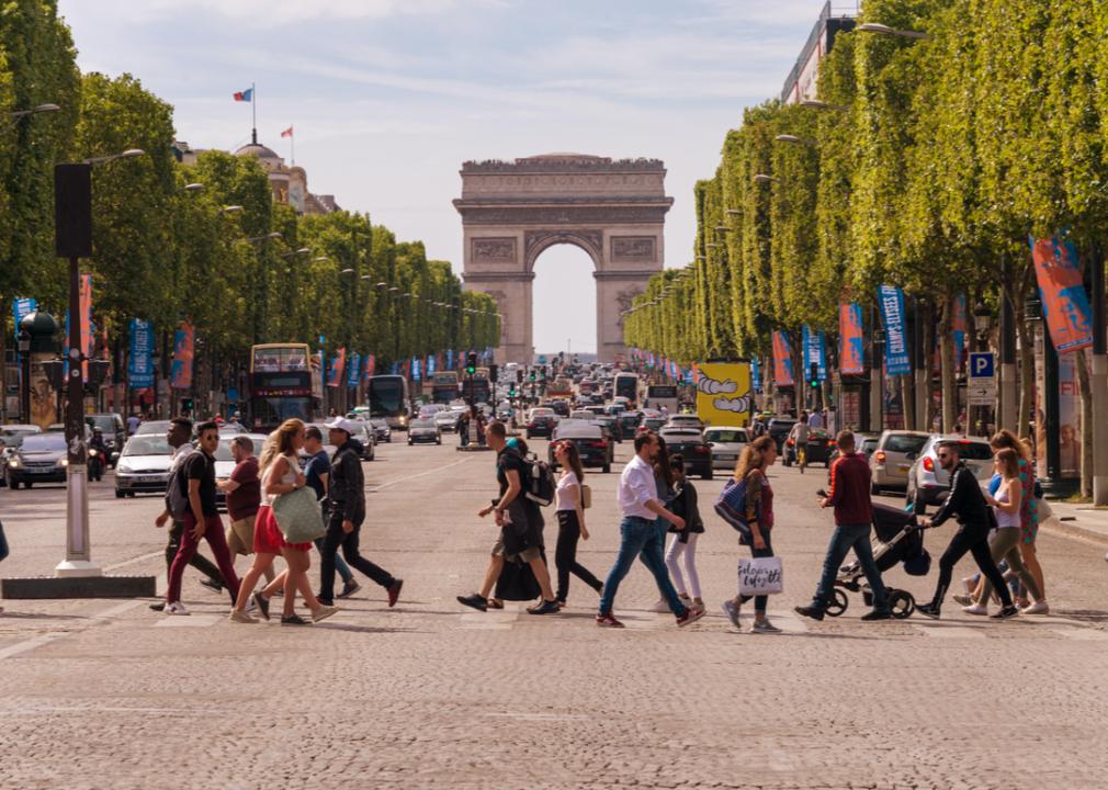 People walking across Champs-Elysees in Paris