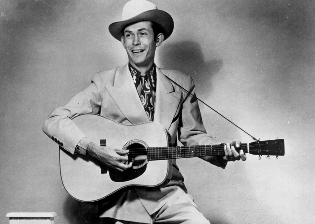 Hank Williams poses for a portrait with guitar.