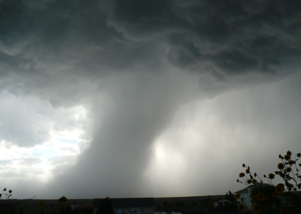 Stormy skies with tornado funnel.