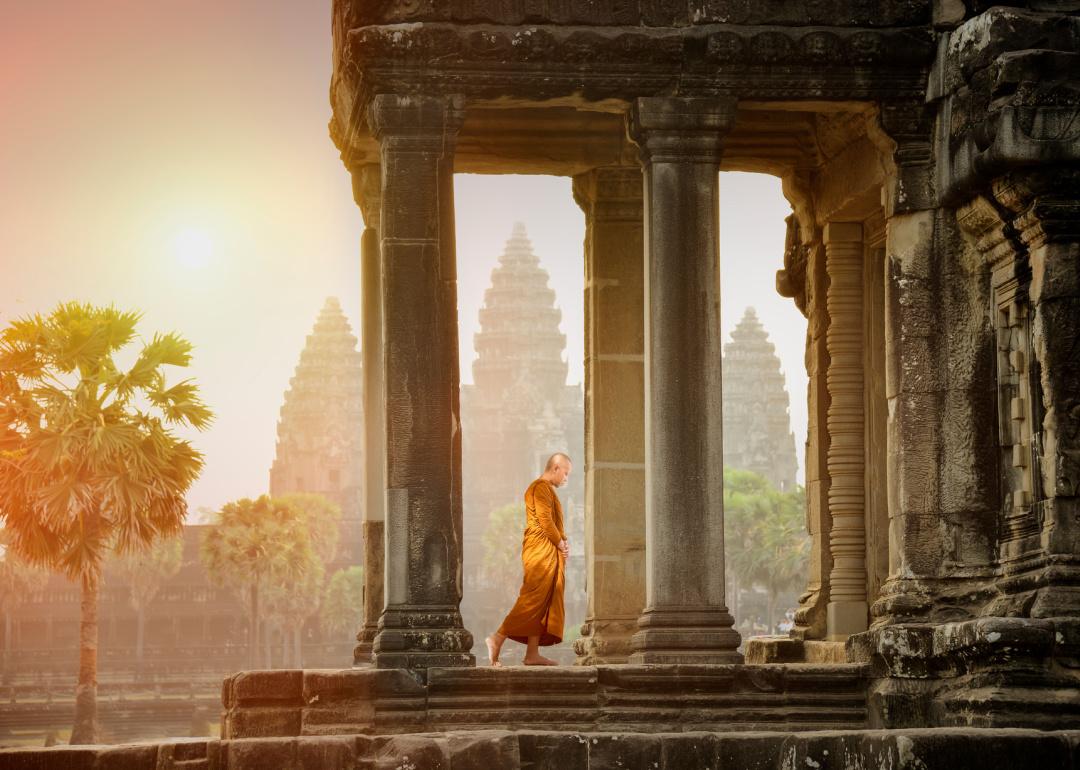 Monk walking in temple landscape at Angkor Wat.