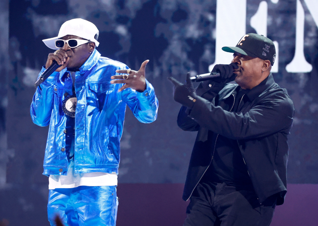 Flavor Flav and Chuck D perform onstage.