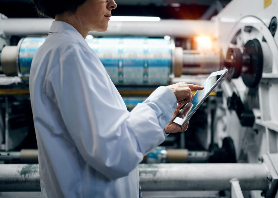 Worker with tablet at polymer manufacturing factory.