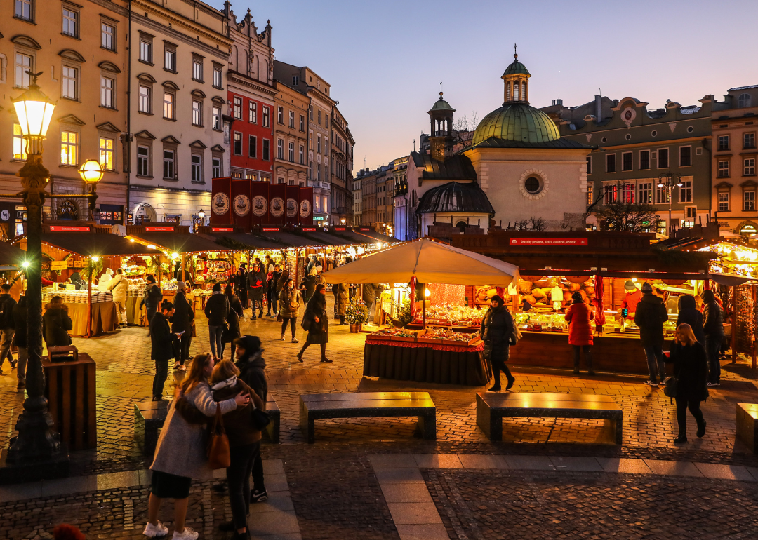 Visitors walk through the Christmas market at the Main Square in Krakow.