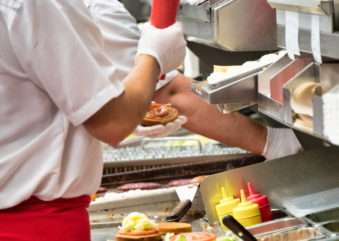 Person preparing hamburgers