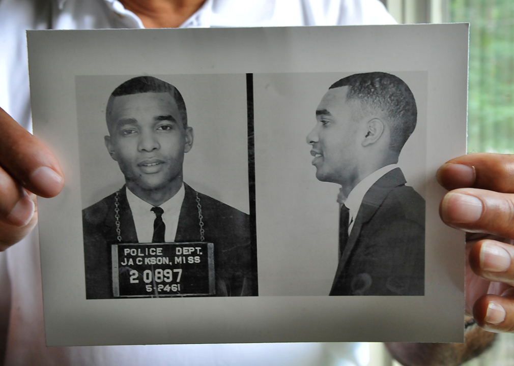 Dion Diamond holds a photograph of his mugshot.