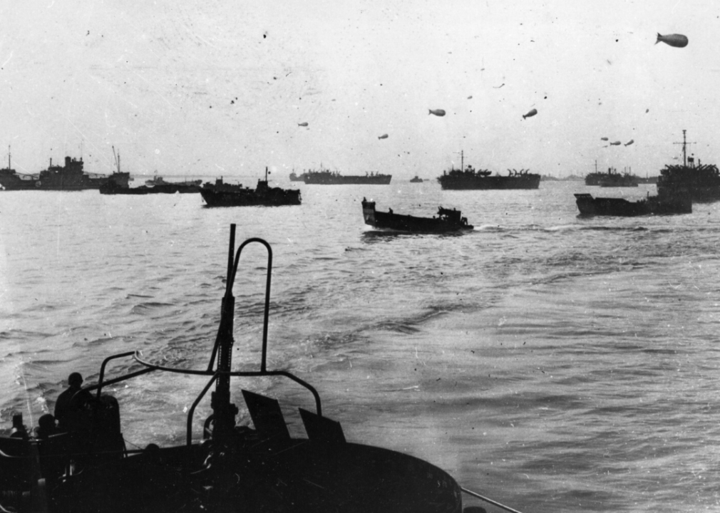 Allied landing craft protected by barrage balloons cross the English Channel on June 6, 1944.