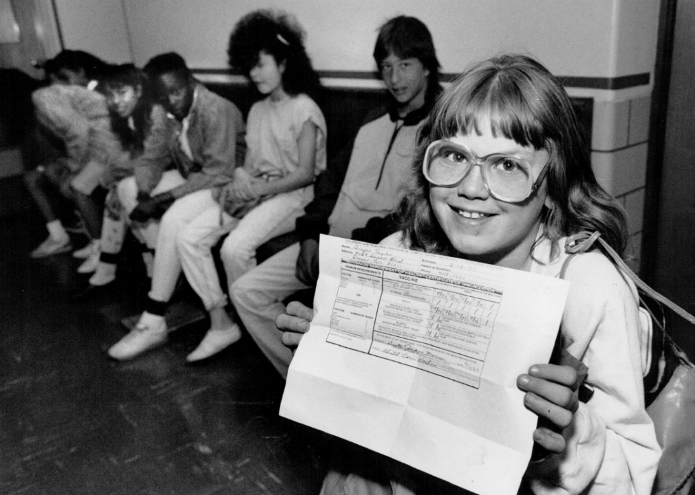 A middle school student shows proof of immunization against measles in 1989