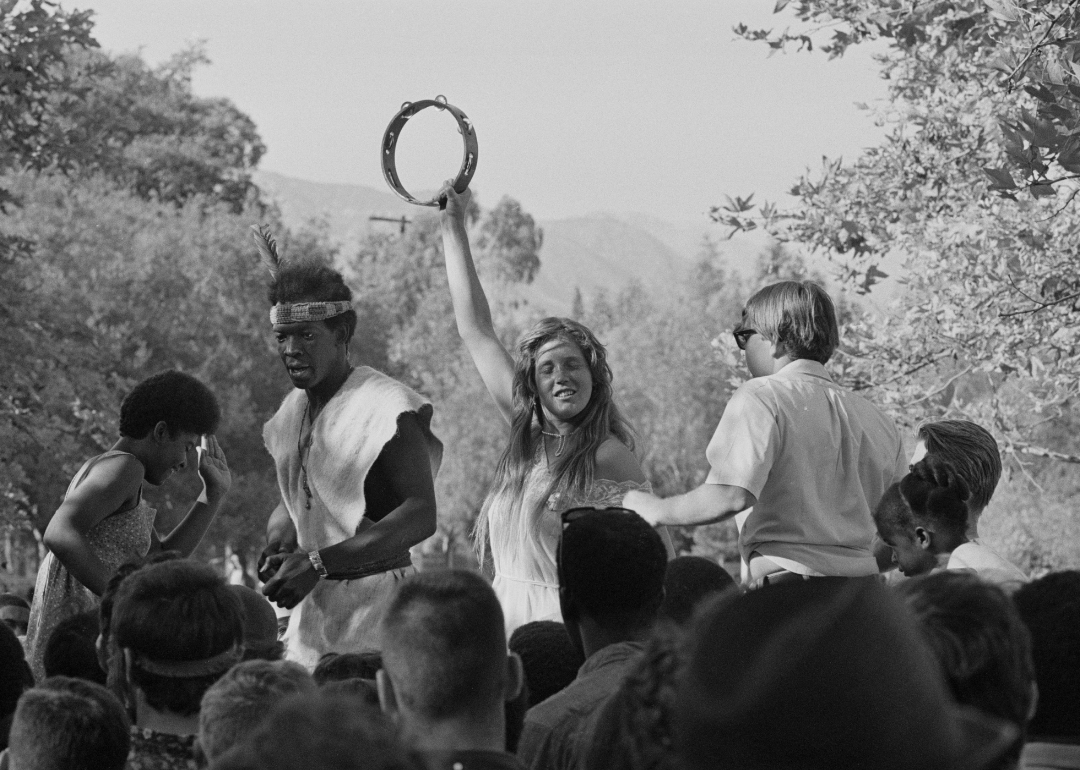 People dancing and playing a at a tambourine at a ‘love-in.'