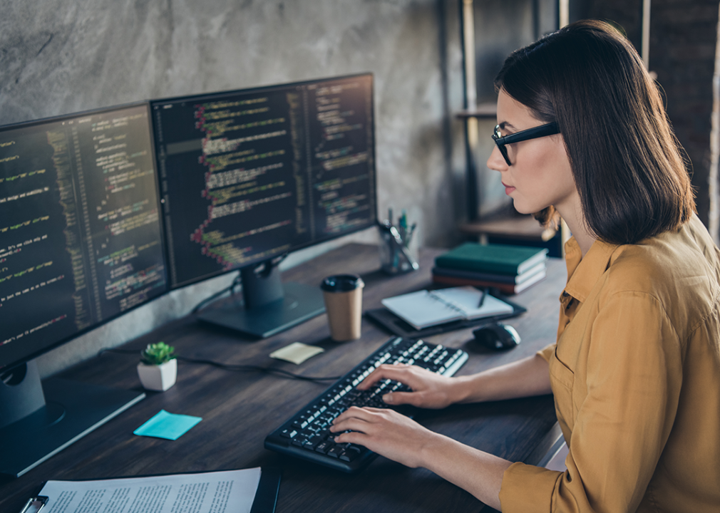 Person typing on keyboard in office.