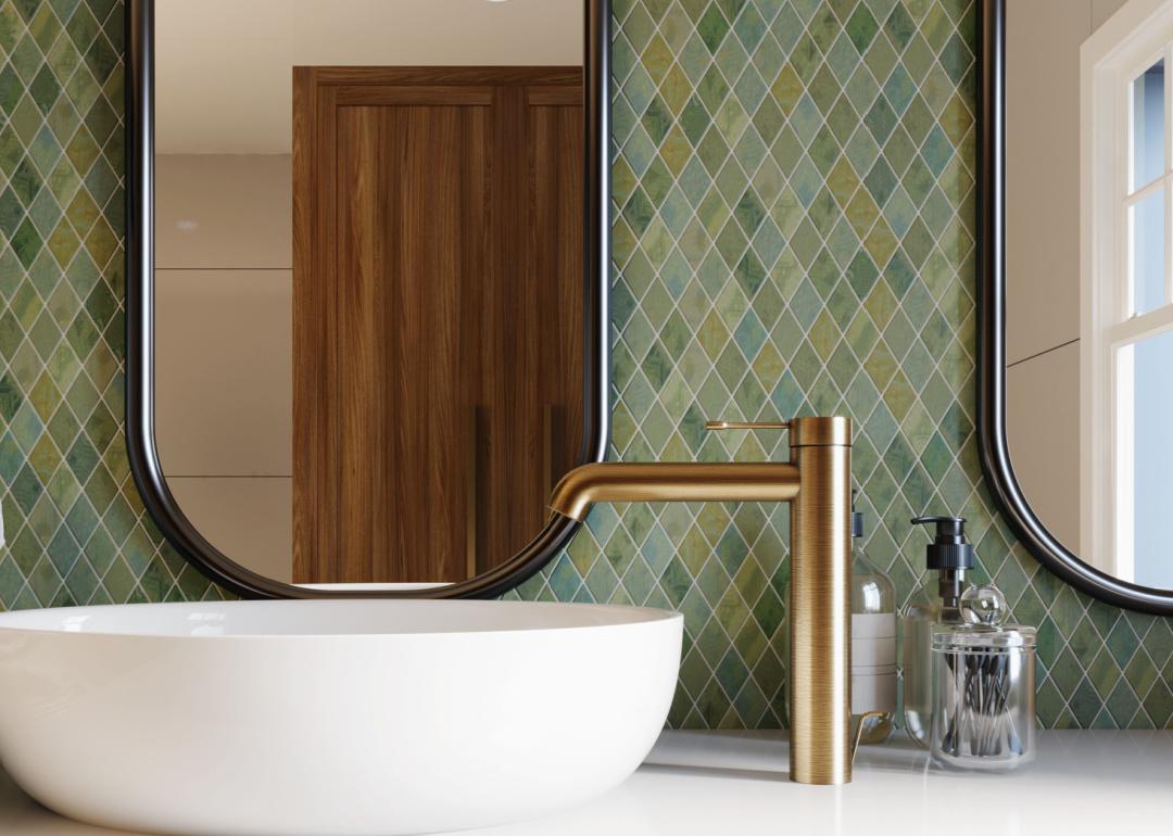 Bathroom with green tiled wall in diamond pattern.