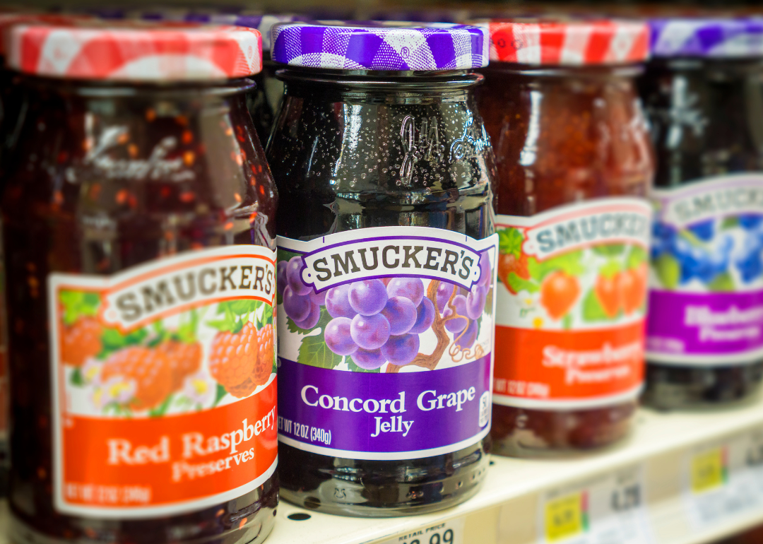 Jars of Smucker's preserves in supermarket.