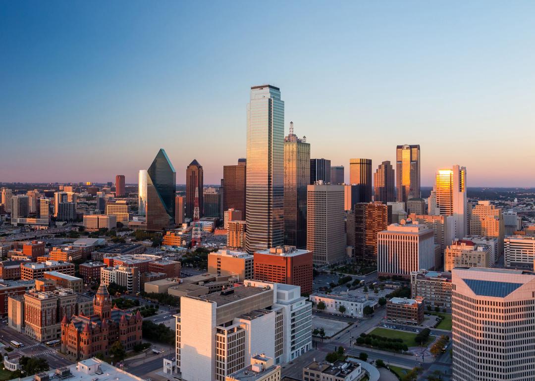 Dallas cityscape with blue sky at sunset.