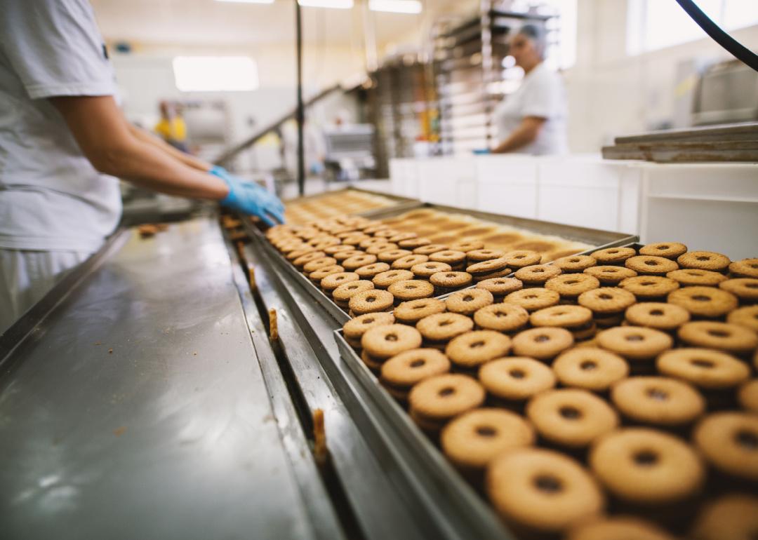 Workers on assembly line at cookie factory.