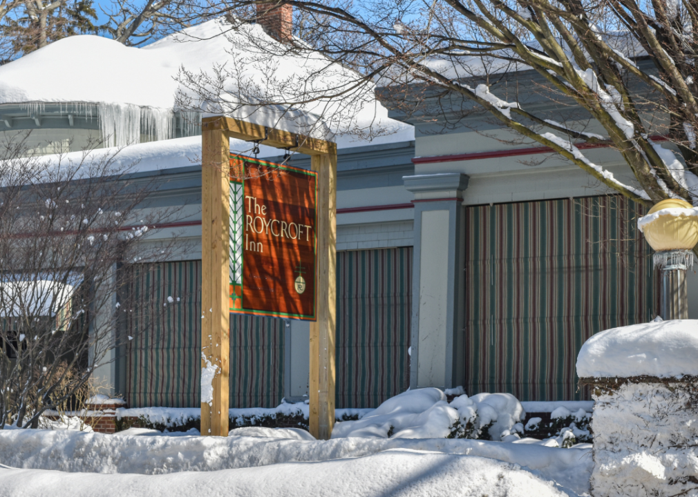 The Roycroft Inn sign outside snowy building.