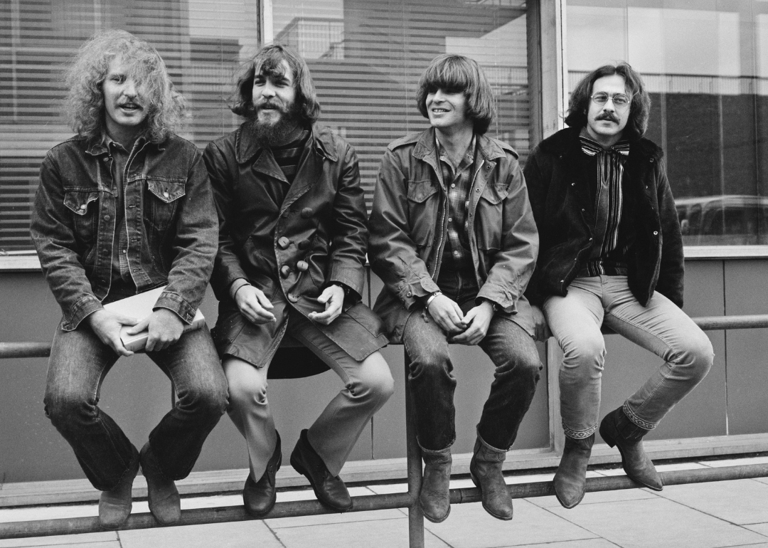 John Fogerty, Tom Fogerty, Stu Cook, and Doug Clifford pose for a portrait.