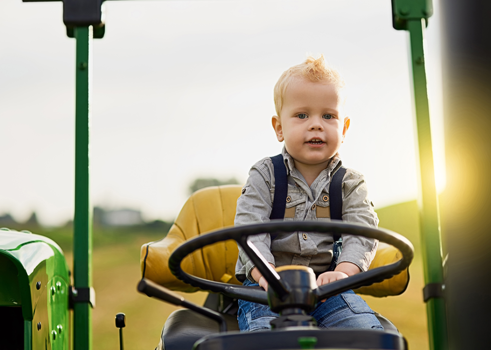 Child playing on tractor.