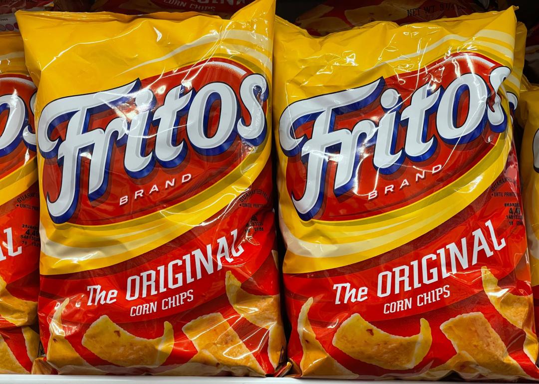 Fritos corn chips bags on shelf.