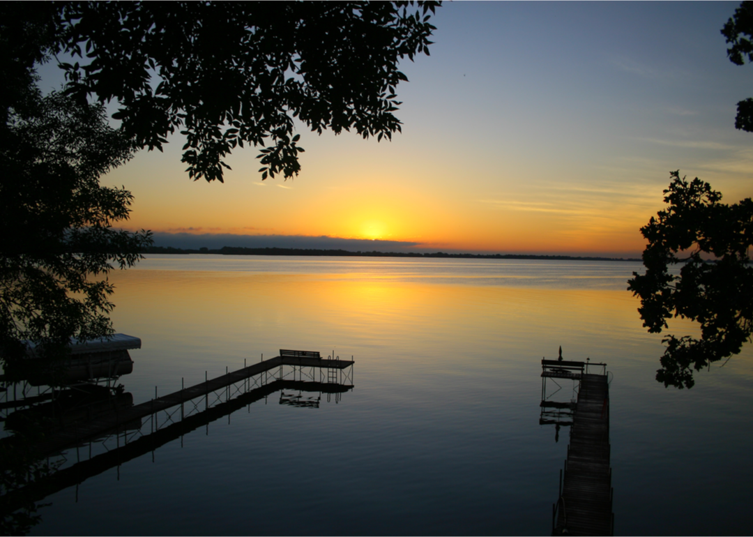 The sun sets over a body of water