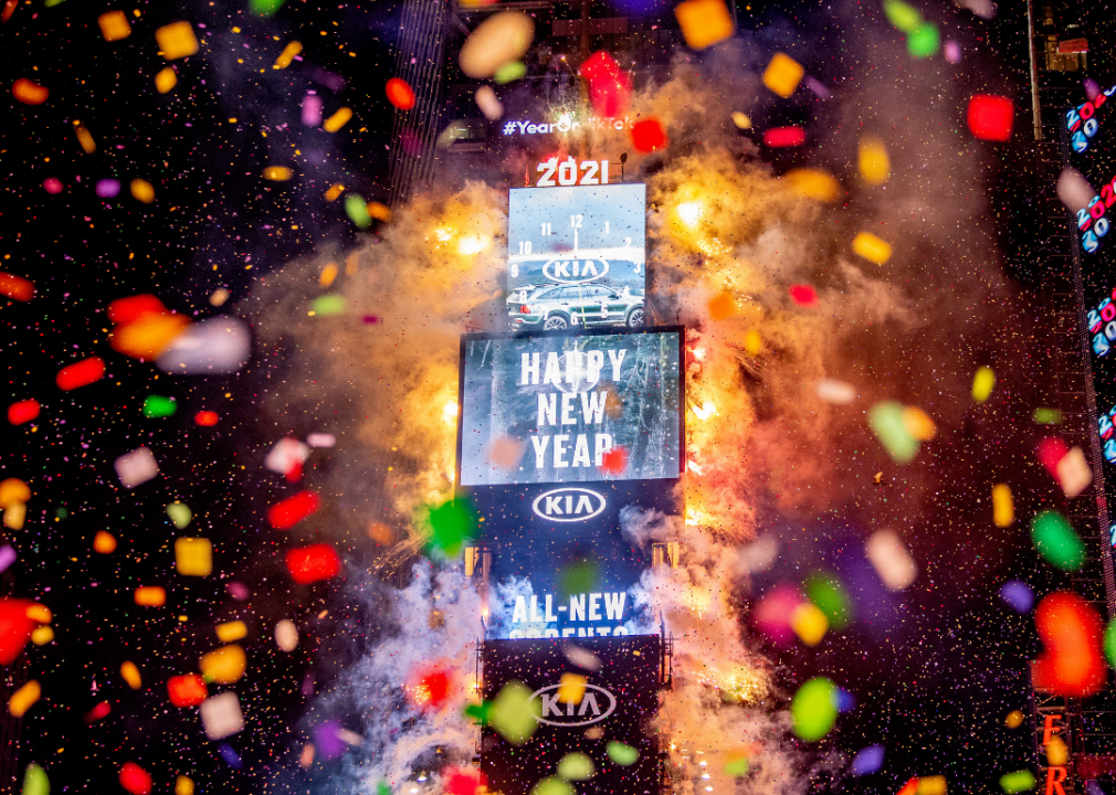 Fireworks and confetti fall over Times Square. 