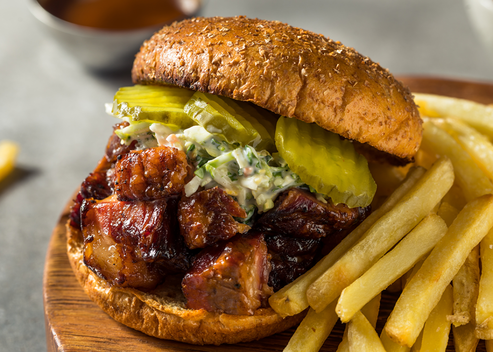 Smoked burnt ends BBQ sandwich with french fries.