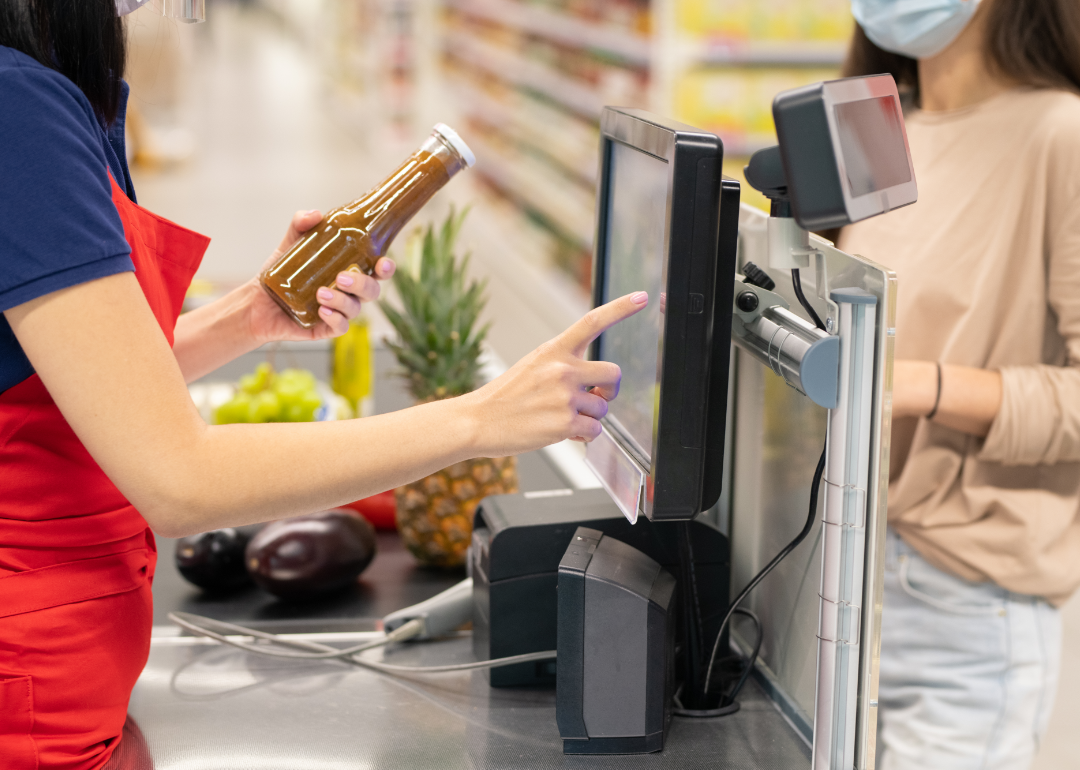 Cashier working grocery checkout