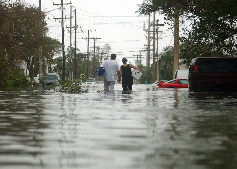 A couple walks in flood waters along South Street in Key West.