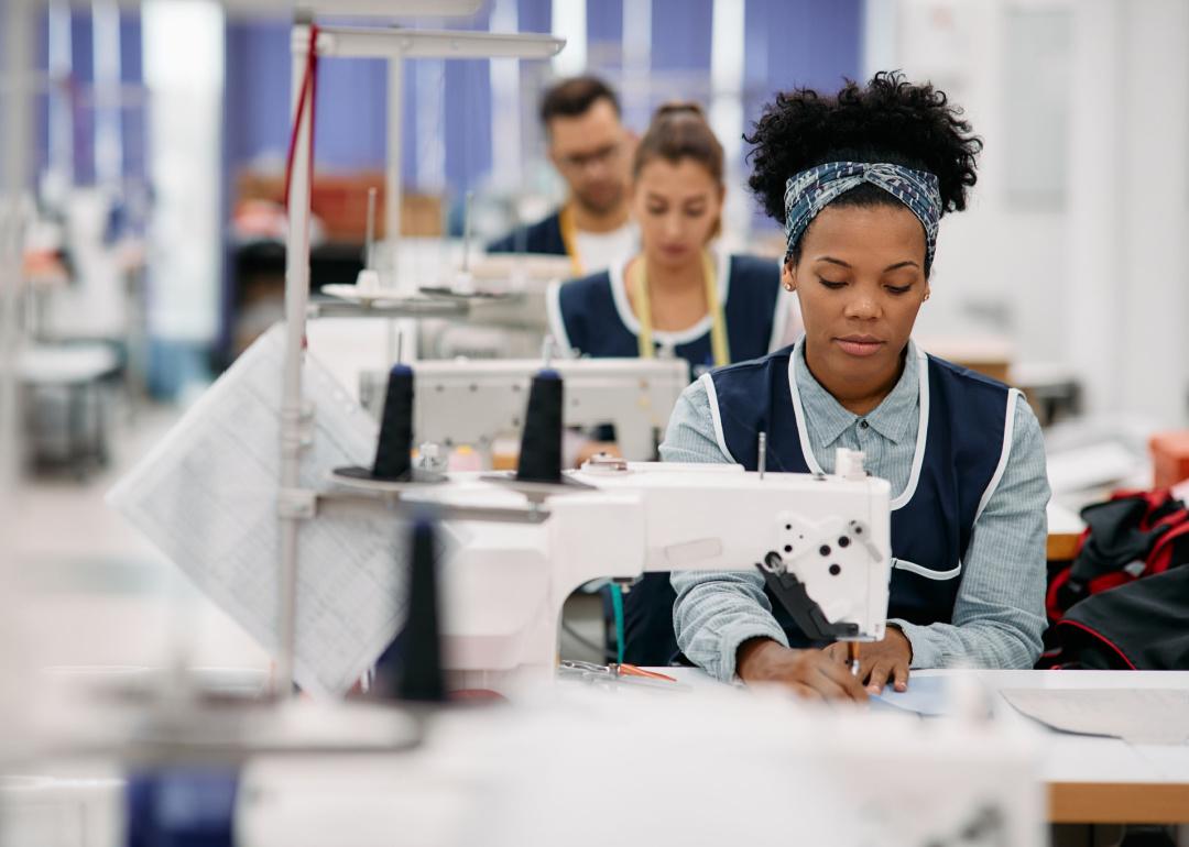 Woman sewing in clothing factory.