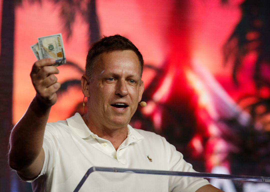 Peter Thiel holding money as he speaks during the Bitcoin 2022 Conference.
