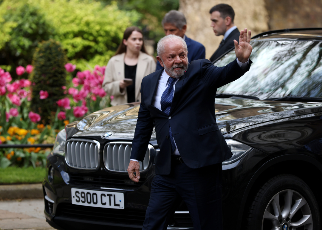 Brazilian President Lula da Silva waves as he arrives in London.
