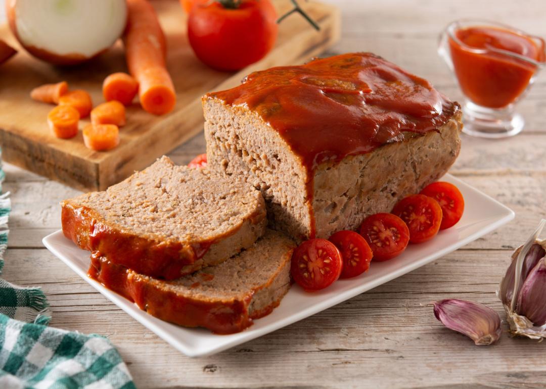American meatloaf with ketchup on platter.