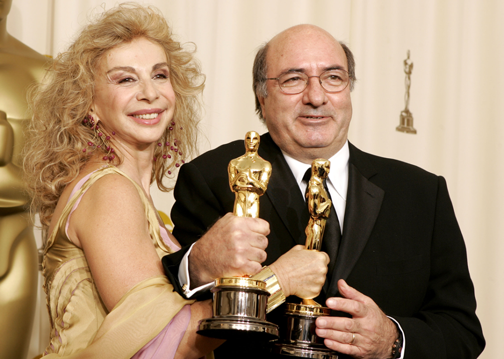 Francesca Lo Schiavo and Dante Ferretti pose with their Oscars for Best Art Direction.