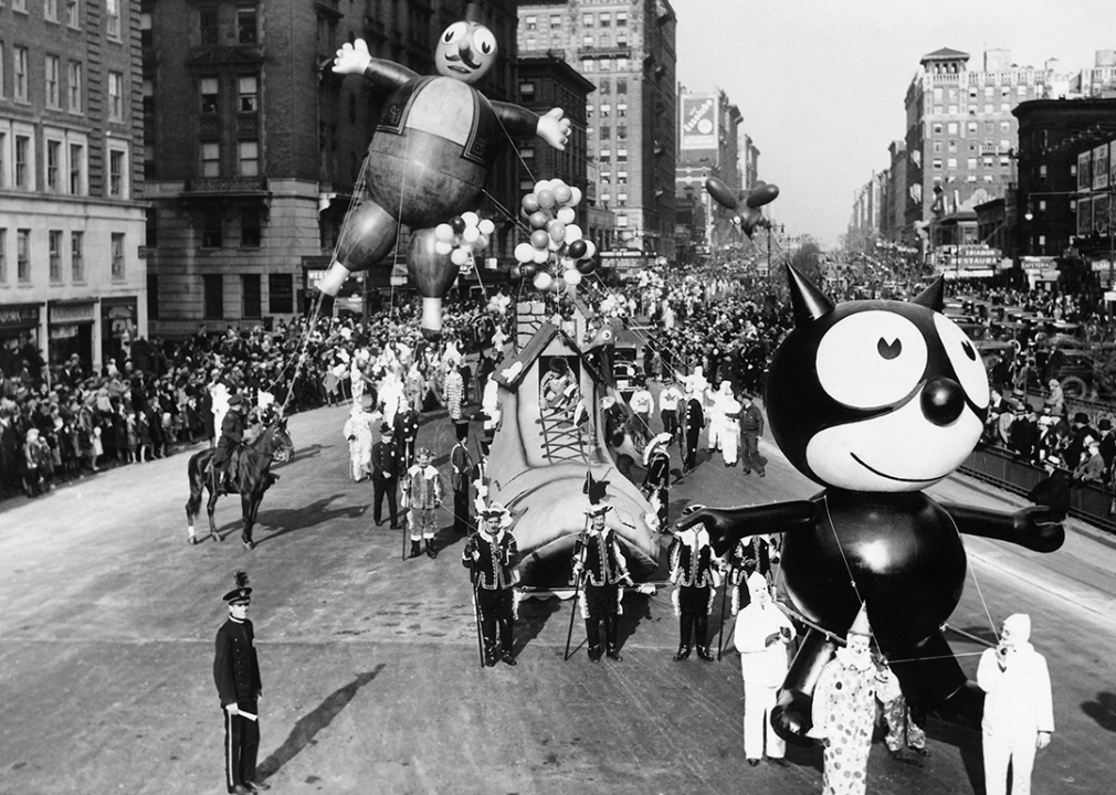 Balloons are led down Broadway in 1932.