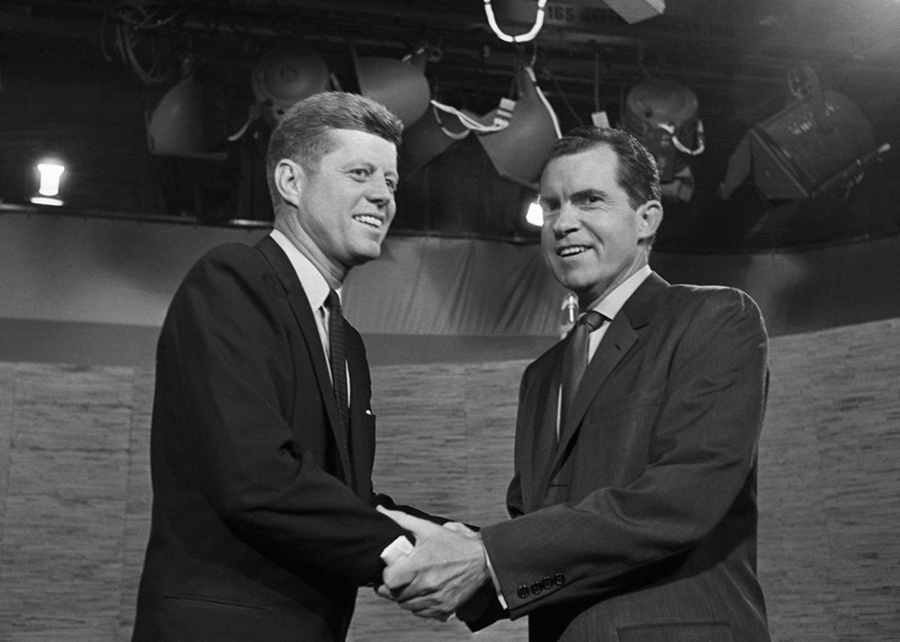 John F. Kennedy and Richard Nixon shake hands after their televised debate.