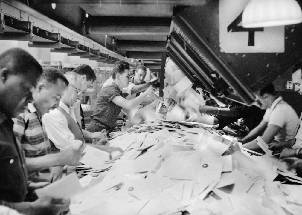 Workers sorting mail