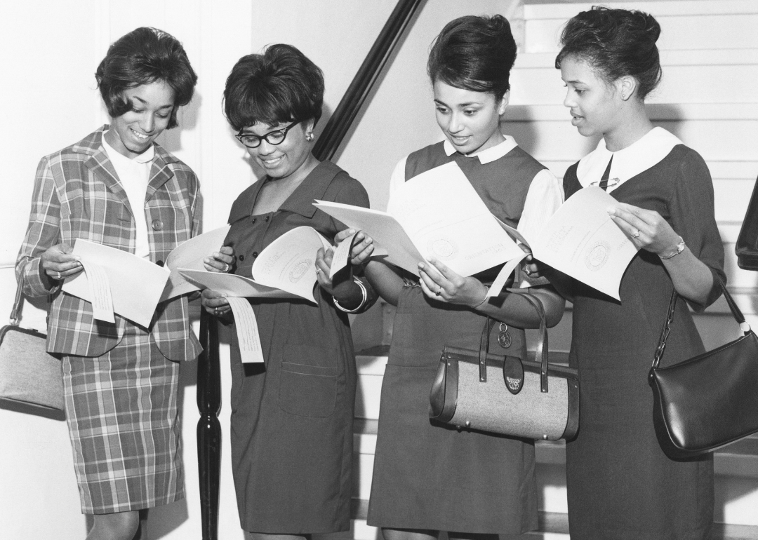 Four Black students in professional-looking dresses and skirtsuits at orientation in 1965 at North Carolina College at Durham.
