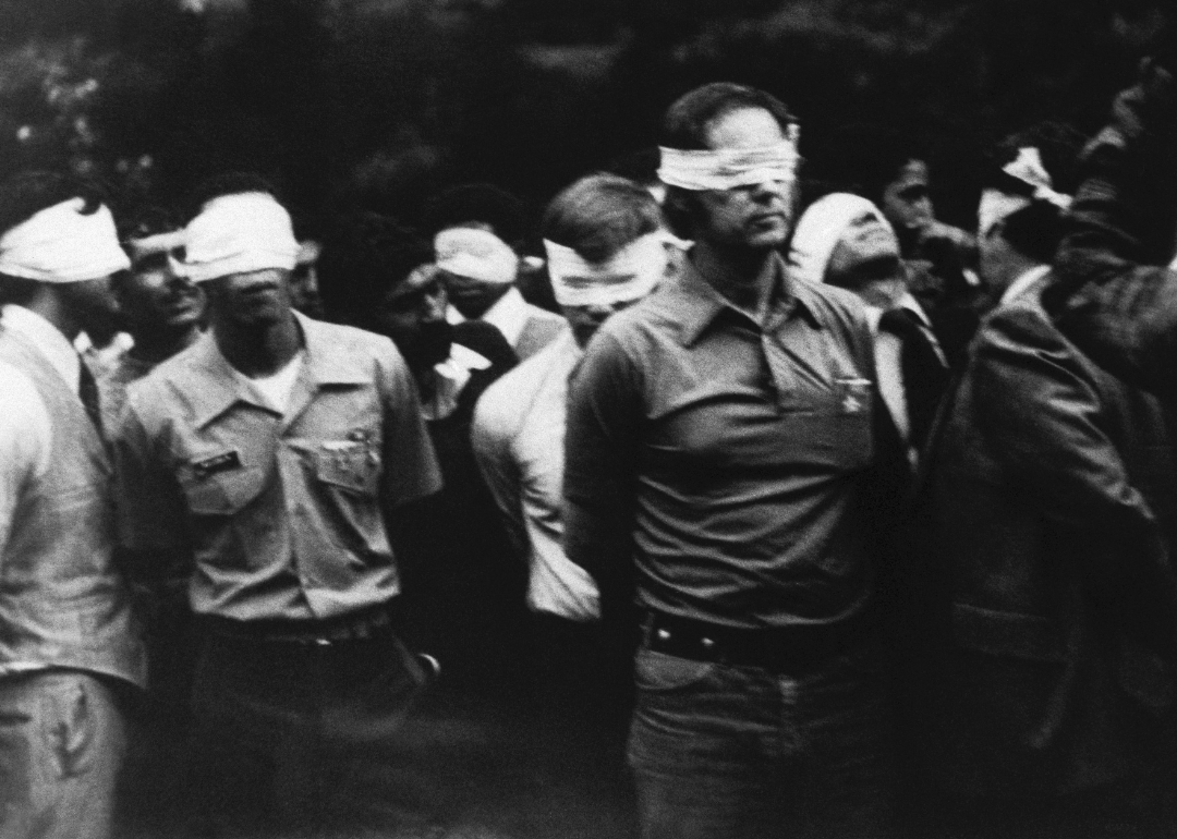 Blindfolded hostages outside US Embassy.