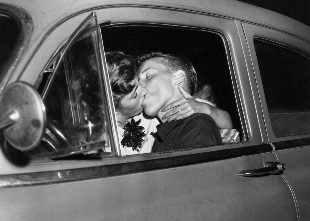 Two teenagers kissing in car.