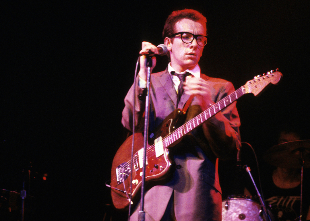 Elvis Costello performing onstage.