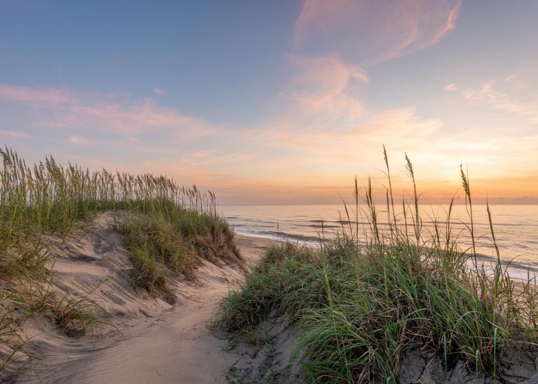 Sand dunes and beach at sunrise in Outer Banks.